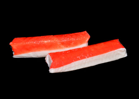 crab sticks isolated on black backgroundの写真素材