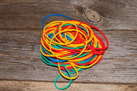 rubber band isolated on wooden background - close-upの写真素材