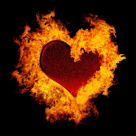 Abstract burning heart isolated on black backgroundの写真素材