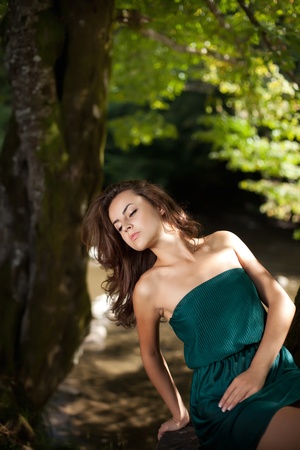 Young woman in the wood near the riverの写真素材