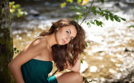 Young woman in the wood near the riverの写真素材