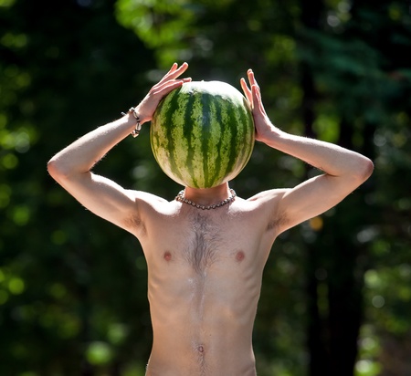 Mr.Watermelon. Humorous photo of a  boy with a watermelon instead of headの写真素材