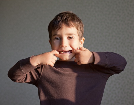 Cute joyful young boy portrait in sunlightの写真素材