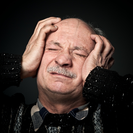 Pain. Elderly man suffering from a headacheのeditorial素材
