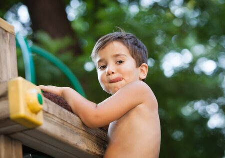 Full of emotion 3-4 years boy playing on the playgroundの写真素材