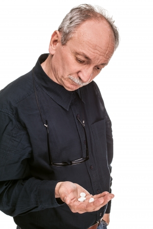 Old man wants to take a pill isolated on whiteの写真素材