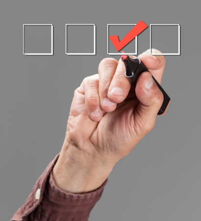 hand with pen mark the check boxesの写真素材