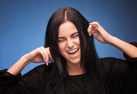 pretty girl closing her ears with fingers の写真素材