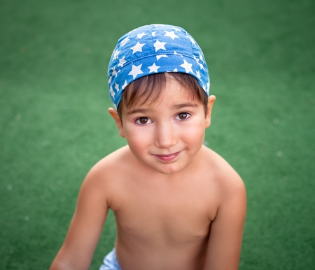cute young boy wearing bandana outside portraitの写真素材