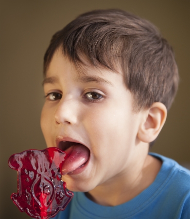 Close Up of Young Boy Eating A Lollipopの写真素材