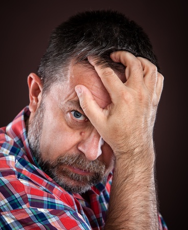 Portrait of a thoughtful elderly man with hand near the faceの写真素材