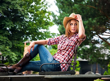 Sexy cowgirl  Young woman portrait in a hatの写真素材