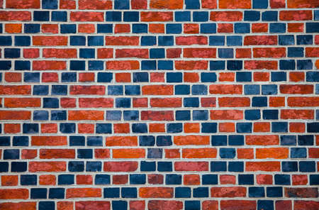 Decorative ornament made ââby red and black bricks on wall of an old houseの写真素材