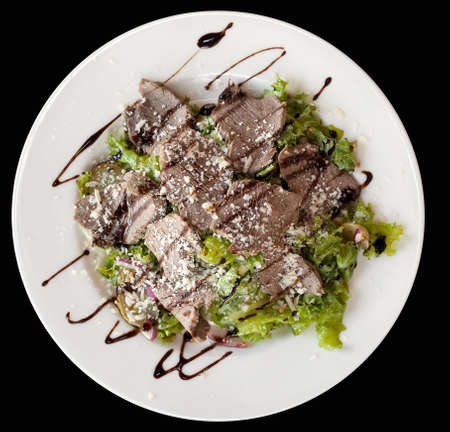 Salad of boiled meat, lettuce and sauce sprinkled with cheeseの写真素材