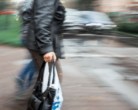 Group of people crossing the street at a crosswalk. Intentional motion blur