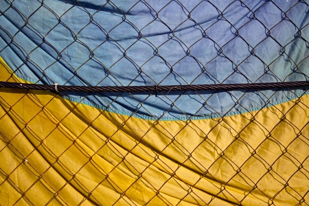 KIEV, UKRAINE - January 26, 2014: Mass anti-government protests in the center of Kiev. Ukrainian flag on the fence near the barricadesのeditorial素材