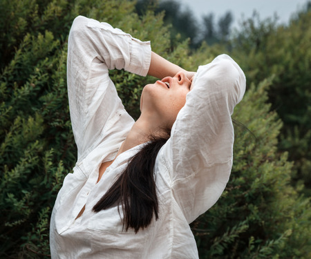 Young beautiful woman resting in the garden