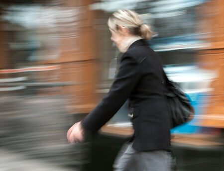 Woman  walking in the street. Intentional motion blurの写真素材