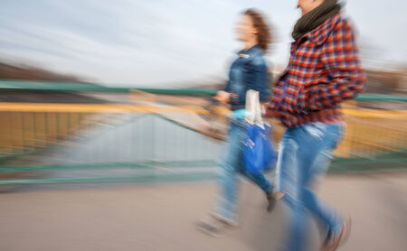 A group of young people going along the street. Intentional motion blur
