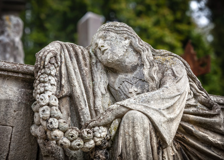 Old statue on grave in the Lychakivskyj cemetery of Lviv, Ukraine.の写真素材