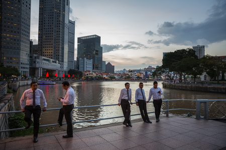 SINGAPORE - DECEMBER 9, 2014: Evening view of the Singapore River. The Singapore River Cruise is a tourist attraction in this former British colony.のeditorial素材