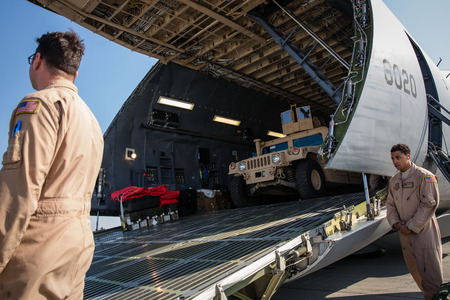 KIEV, UKRAINE - Mar. 25, 2015: US armored vehicles HMMWV (Humvee) on board the aircraft of the US...
