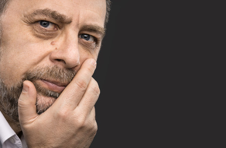 Portrait of handsome senior man with a tired expressionの写真素材