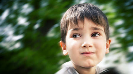 Happy little boy smiling on blurred backgroundの写真素材