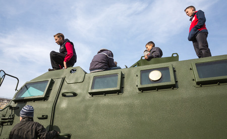 KIEV, UKRAINE - Oct 17, 2015: Exhibition of military equipment "Power of Unbroken" on the occasion of the Day of Defender of Ukrain. Children are considering military equipmentのeditorial素材