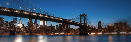 Manhattan Skyline and Manhattan Bridge At Night. Defocused image with blurred edges and  foreground....