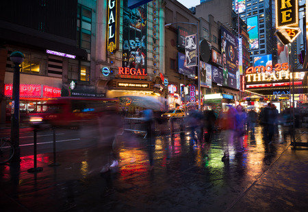 NEW YORK, USA - Apr 30, 2016: Lights and shadows of New York City. NYC streets after rain with reflections on wet asphalt. Silhouettes of people walking on the streetのeditorial素材