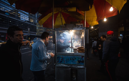 NEW YORK, USA - Apr 30, 2016: Fast food on the streets of Manhattan at night. Manhattan street scene. The Americans on the streets of New York Cityのeditorial素材