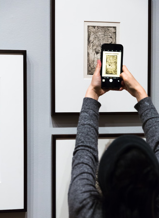 NEW YORK, USA - May 01, 2016: People inside Museum of Modern Art. MoMAs collection offers an overview of modern and contemporary art, architecture, design, drawing, painting, sculpture, photographyのeditorial素材