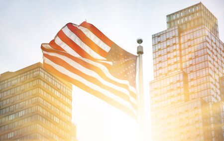 NEW YORK, USA - Apr 29, 2016: View of American flag in the rays of  rising sun on background of...