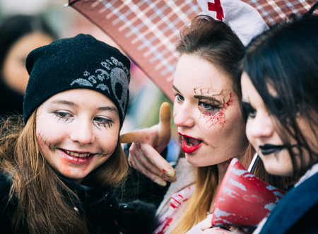 KIEV, UKRAINE - Oct 30, 2016: Zombie Walk. Young people taking part in a zombie parade in the streets of Kiev, to celebrate Halloween.Street performer in Halloween costume and makeup.のeditorial素材