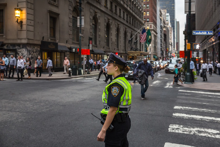 NEW YORK, USA - Sep 20, 2016: New York and New Yorkers. Manhattan street scene. Young woman police officer at Manhattan streets in evening timeのeditorial素材