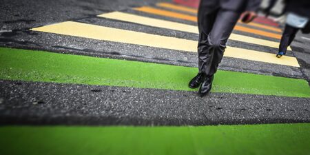 Zebra crossing. Man cross street at crosswalk in the cityの写真素材