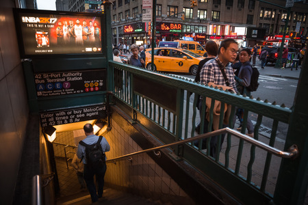 NEW YORK, USA - Sep 20, 2016: Blurred people walking in front of NYC subway entrance in evening...