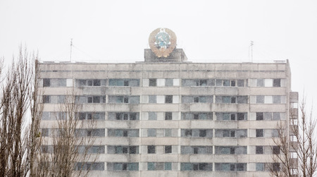 CHERNOBYL REG, UKRAINE - Nov 29, 2016: Chernobyl Exclusion Zone. Snowfall in lost city. Ruins of buildings in the abandoned city of Pripyat. Winter in zone of exclusion. Zone of high radioactivityのeditorial素材