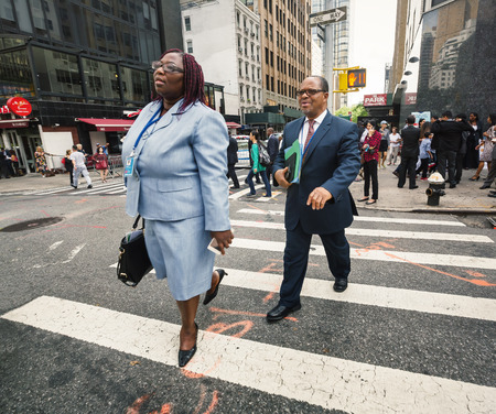NEW YORK, USA - Sep 20, 2016: New York and New Yorkers. Manhattan street scene. The Americans on the streets of New York City. A black woman in a business suit and a black man go to work early morningのeditorial素材