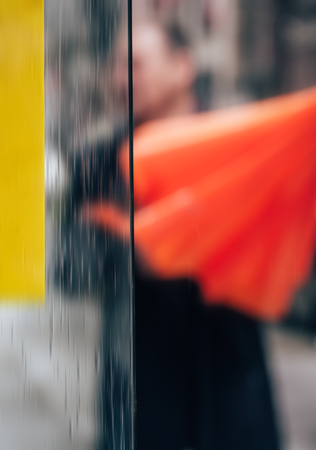 Rain in the city. Blurred scene of urban life. Emotional abstract background with defocused people on the streets of New York on a rainy dayの写真素材