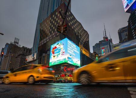 NEW YORK, USA - Apr 30, 2016: Crossroad of 8th Ave and 42nd st. Lights and shadows of NYC. Lights of advertising on streets of Manhattan at evening time. Blurred cars in foregroundのeditorial素材