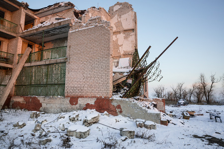 DONETSK REGION, UKRAINE - Dec 18, 2016: Destroyed houses and ruins, mechanisms, chaos and deserted village due to the war in eastern Ukraineのeditorial素材
