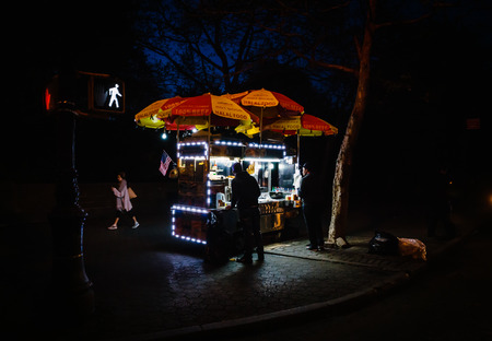 NEW YORK, USA - May 03, 2016: Manhattan street scene. Fast food cart in New York City at nightのeditorial素材