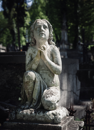 LVIV, UKRAINE - Apr 27, 2016: Old statue on grave in the Lychakivskyj cemetery of Lviv, Ukraine. Officially State History and Culture Museum-Preserve - Lychakiv Cemeteryのeditorial素材