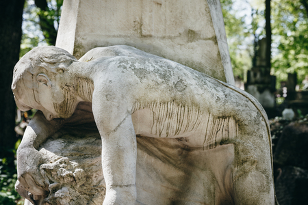 LVIV, UKRAINE - Apr 27, 2016: Old statue on grave in the Lychakivskyj cemetery of Lviv, Ukraine. Officially State History and Culture Museum-Preserve - Lychakiv Cemeteryのeditorial素材