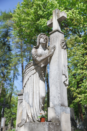 LVIV, UKRAINE - Apr 27, 2016: Old statue on grave in the Lychakivskyj cemetery of Lviv, Ukraine. Officially State History and Culture Museum-Preserve - Lychakiv Cemeteryのeditorial素材