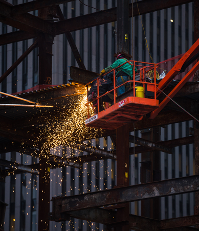 NEW YORK, USA - Apr 30, 2016: Workers on the construction site. Metal welding work at the construction site in Lower Manhattan. Sparks from welding workのeditorial素材