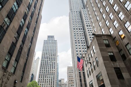 NEW YORK, USA - May 05, 2016: Buildings and skyscrapers of Manhattan. American flag on the streets of Manhattan, New York Cityのeditorial素材