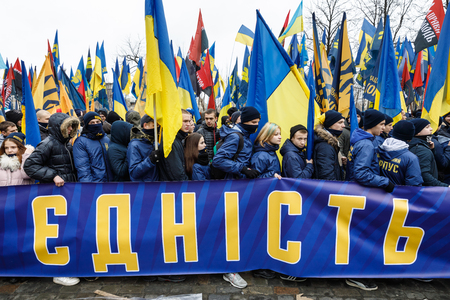 KIEV, UKRAINE - Feb 22, 2017: Activists of nationalist groups during the March of National Dignity.  Inscription on the poster - unityのeditorial素材